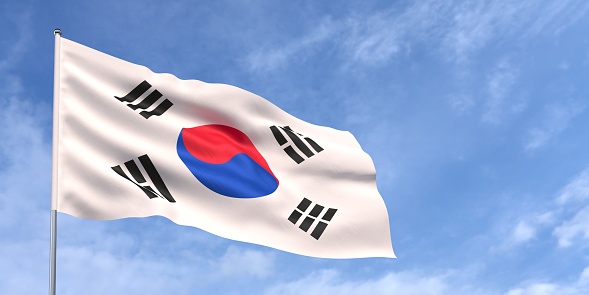 South Korea flag on flagpole on blue sky background. Korean flag waving in the wind on a background of sky with white clouds. Place for text. 3d illustration.