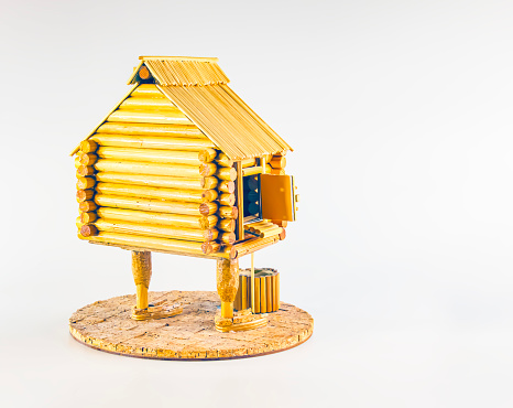 A figurine of a wooden house on chicken legs. Baba Yaga's house. Handmade.