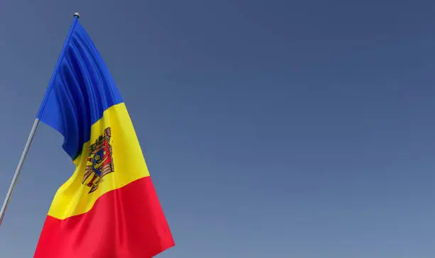 Photo of Moldova flag on flagpole on blue background. Place for text. The flag is flutters in wind. Moldavian, Chisinau. Europe. 3D illustration.