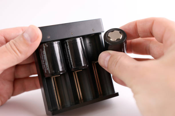Charger with batteries inserted for charging. Powering household gadgets.