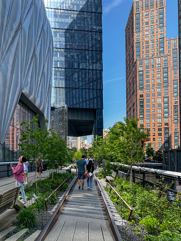 May 11 , 2023 - Hudson Yards,  Midtown Manhattan, New York City, NY, USA: People walking between the rails and skyscrapers at the end of High Line Park in New York City