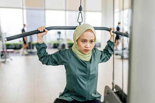 South East Asian woman exercising cardio in the gym