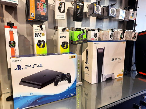 Cairo, Egypt, February 9 2024: Play station PS4 PS5 by Sony, a video gaming brand that consists of five home video game consoles, two handhelds, a media center, and a smartphone and online services, selective focus