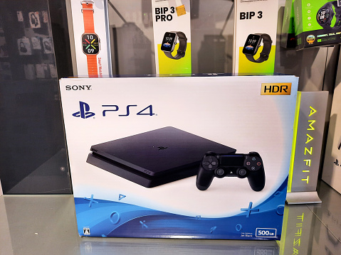 Cairo, Egypt, February 9 2024: The PlayStation 4 (PS4), a home video game console developed by Sony Interactive Entertainment. Announced as the successor to the PlayStation 3 in February 2013, selective focus