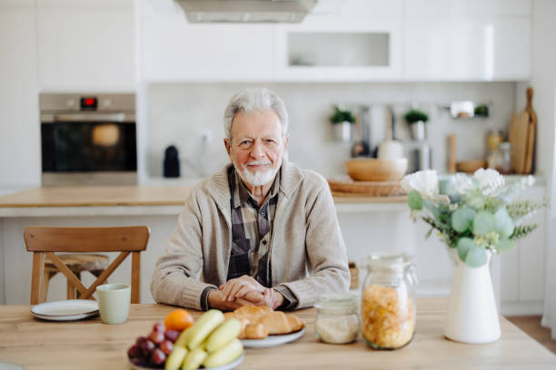 istock Senior man having breakfast at home 2020623948