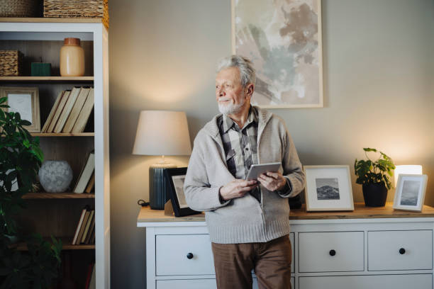istock Portrait of senior man using digital tablet at home 2020633067