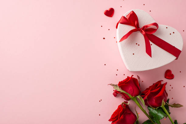 istock Perfect feminine jubilee framework: Overhead image of exquisite rose ensemble, stylish heart box, decorative items, glitter on pale pink background, intentionally left with space for textual content 2020640616