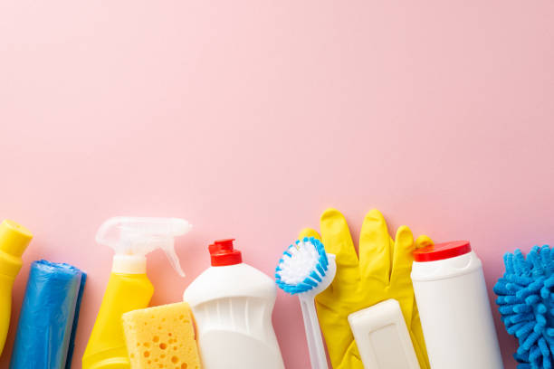 istock Cleaning kit essentials artfully arranged: top view liquid cleaners, dusting cloth, protective gloves, garbage bags and sponge, on a minimalist pink background with space for text or ads 2020640644