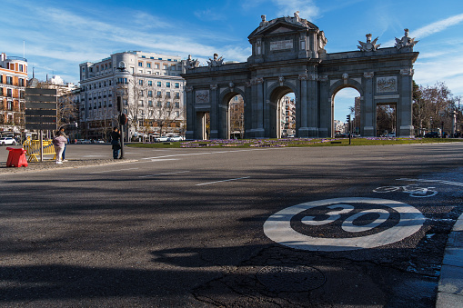 Madrid, Spain - January 28, 2024: The Puerta de Alcala Neo-classical gate in the Plaza de la Independencia. Newly restored iconic monument