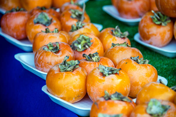 Persimmon (kaki) fruits at rural market in Hakodate, Japan.