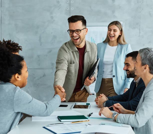 istock young business people meeting office handshake hand shake shaking hands teamwork group contract agreement black happy smiling success partnership introduction greeting 2020674653