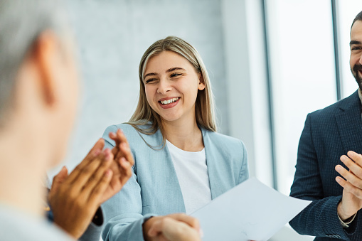 Group of young business people having a meeting or presentation and seminar standing in the office. Portrait of a young business woman talking