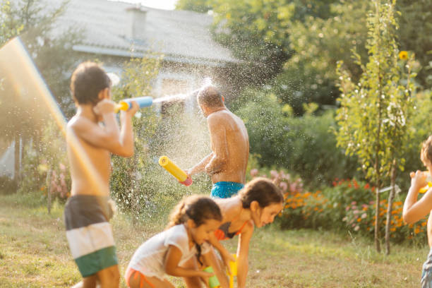 istock Children having a water fight on a hot summer day 2020699724