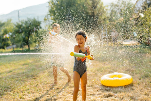 istock Children having a water fight on a hot summer day 2020702418