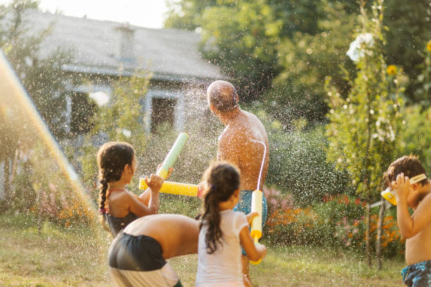 istock Children having a water fight on a hot summer day 2020703998