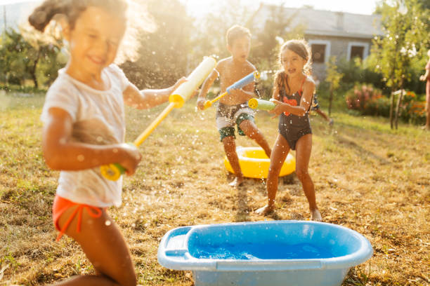 istock Children having a water fight on a hot summer day 2020704528