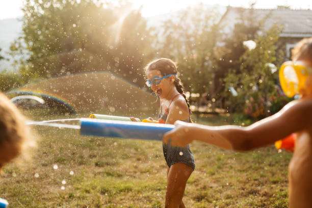 istock Children having a water fight on a hot summer day 2020706701