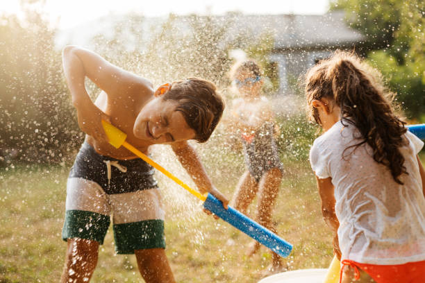 istock Children having a water fight on a hot summer day 2020707339