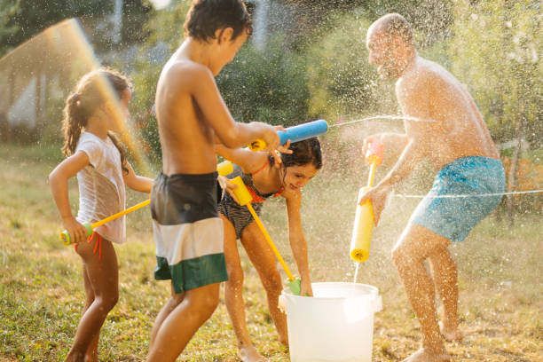 istock Children having a water fight on a hot summer day 2020710993