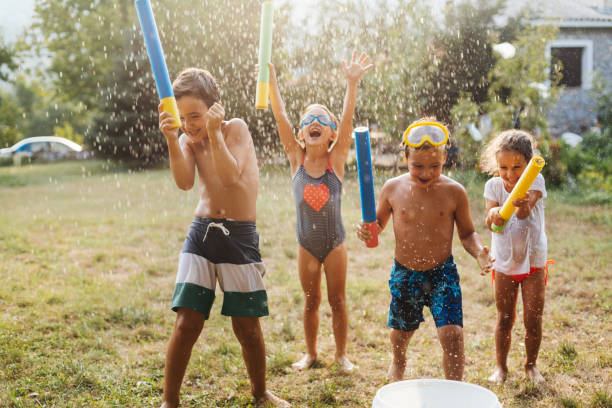 istock Children having a water fight on a hot summer day 2020712114