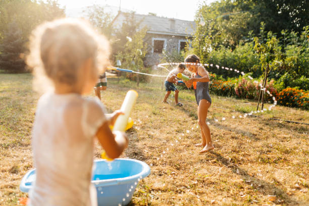 istock Children having a water fight on a hot summer day 2020712660