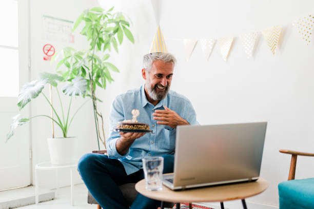 istock Senior man celebrating birthday and having video call at home 2020718207