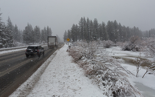 Vehicles traveling on Highway 50 near Lake Tahoe during atmospheric river event.