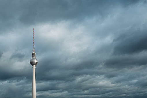 View of the Berlin television tower with a heavily cloudy sky in the background