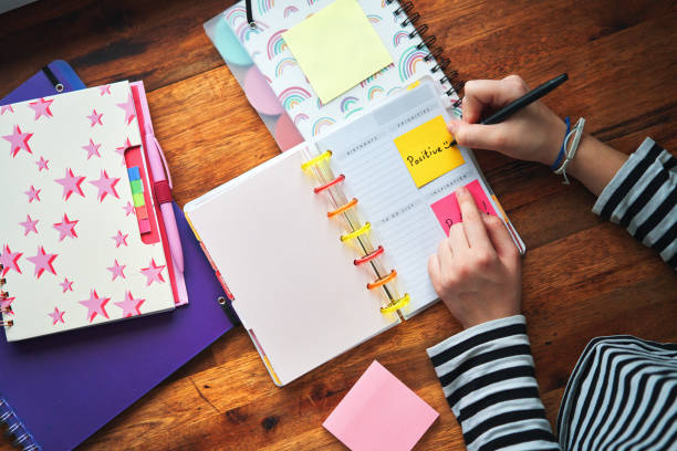 istock Young Girl Writing To-Do-List with Post-Its 2020734152