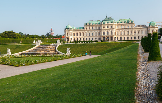 The classical symmetric gardens of the Belvedere palace in Vienna, Austria with its fountain and classic marble sculptures.