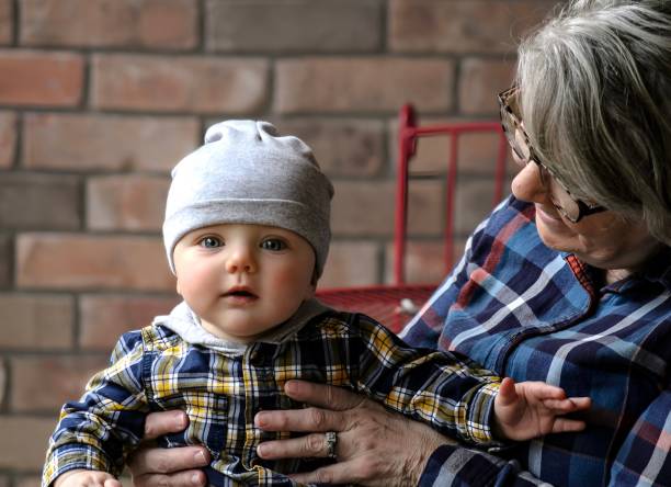 Little boy kisses grandmother's cheek while spending quality time with her