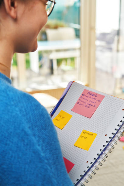 istock Young Girl Writing Post-Its for her School Project at Home 2020743207