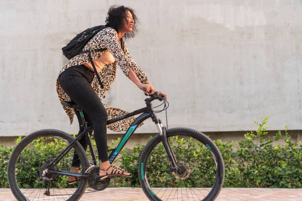 istock Latin Woman Pushing Bicycle Outdoors 2020751306