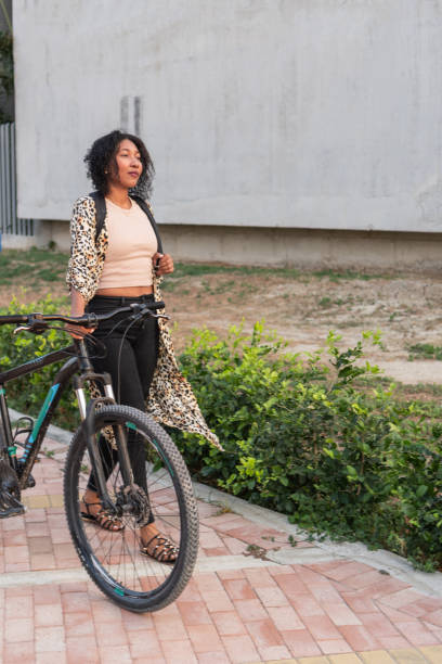 istock Latin Woman with Bicycle in Urban Setting 2020751310