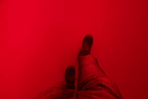 abstract shot of moving legs in a red room