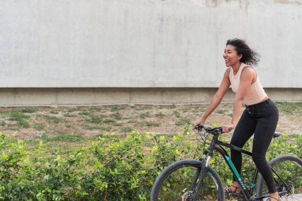 istock Joyful Woman Riding Bicycle on a Sunny Day 2020753505