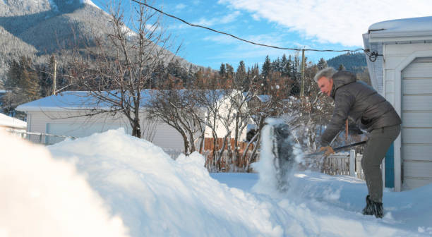 istock Mature man shovels snow from walkway 2020763692