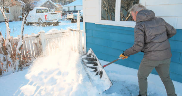 istock Mature man shovels snow from walkway 2020764231