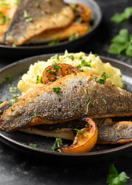 istock Pan fried sea bass fillets served with mashed potatoes and caramelised lemon 2020782423