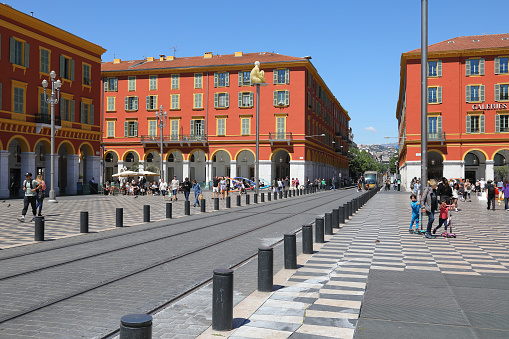 Nice, France - May 3, 2023: Place Massena, the main square of the city and its buildings, tram line that runs here. There is usually a lot of pedestrian traffic in this square.