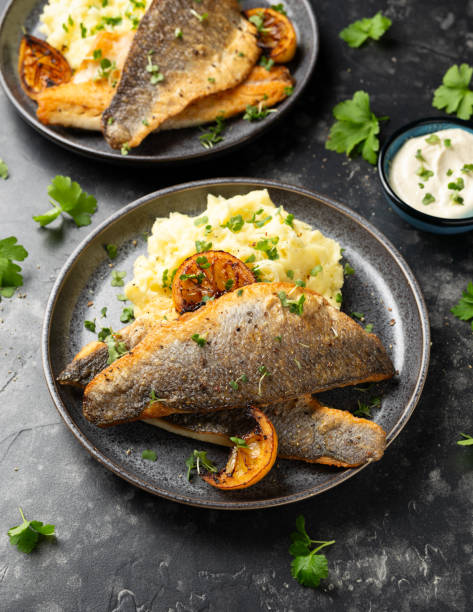 istock Pan fried sea bass fillets served with mashed potatoes and caramelised lemon 2020784059