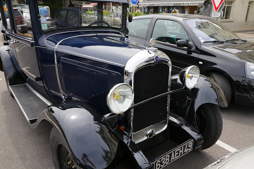 Saumur, France - June 13, 2010: A vintage Citroen C4, built between 1928 and 1932, can be seen parked in an open-air car park among other contemporary cars.