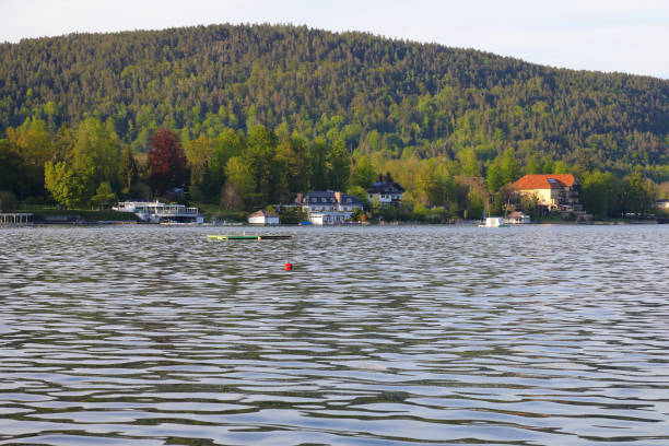 Velden Am Worthersee, Austria - May 4, 2023: With views across the lake to wooded hills and houses in the heart of beautiful countryside, this is a great place for a holiday.
