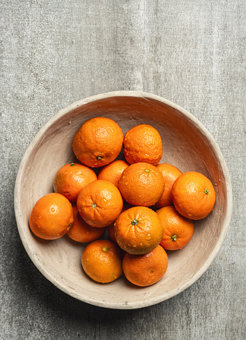 Tangerines on wooden  bowl isolated on white background