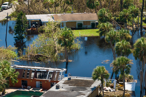 Aftermath of natural disaster. Flooded houses by hurricane rainfall in Florida residential area.