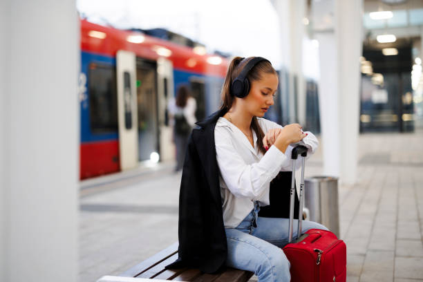istock Woman checking time on train station 2020868511