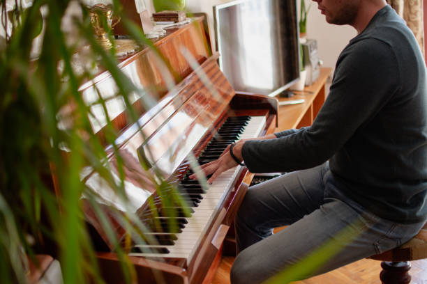 istock a young man plays the piano 2020868530