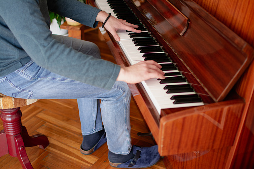 a young man plays the piano