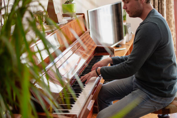 istock a young man plays the piano 2020870103