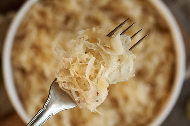 istock Homemade fermented cabbage or sauerkraut on a metal fork 2020873851
